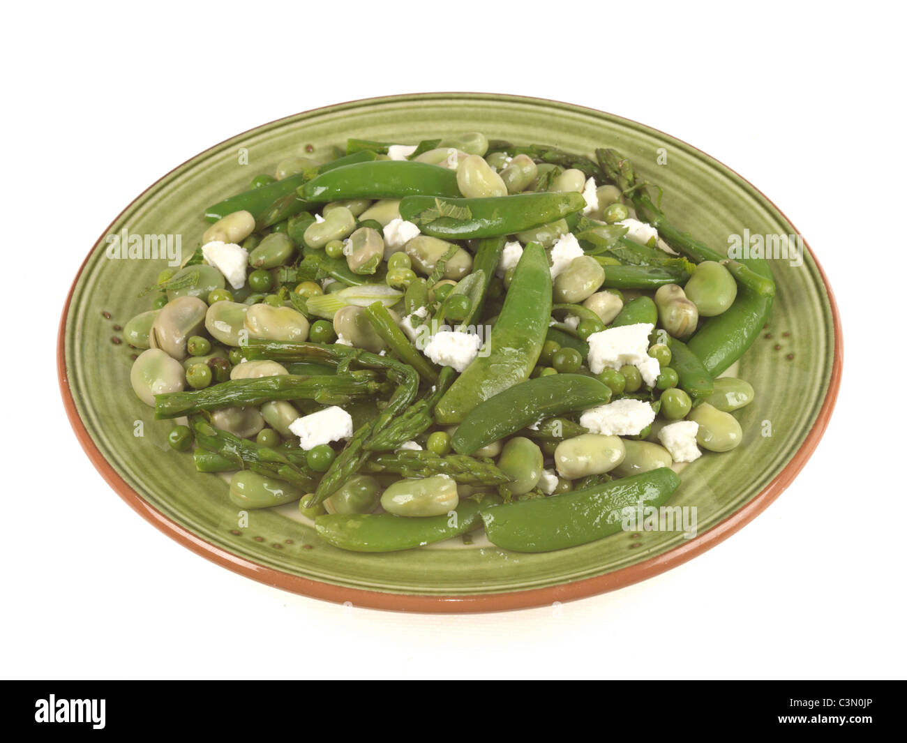 Freshly Prepared Health Broad Bean Salad With Fresh Peas And Feta Cheese Against A White Background With No People And A Clipping Path Stock Photo