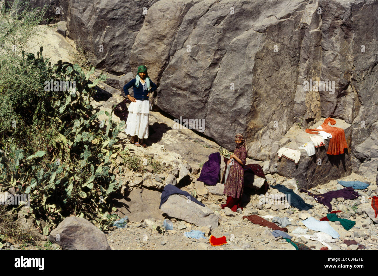 Yemen Young Girl Helping Her Mother With Washing Drying The Clothes On