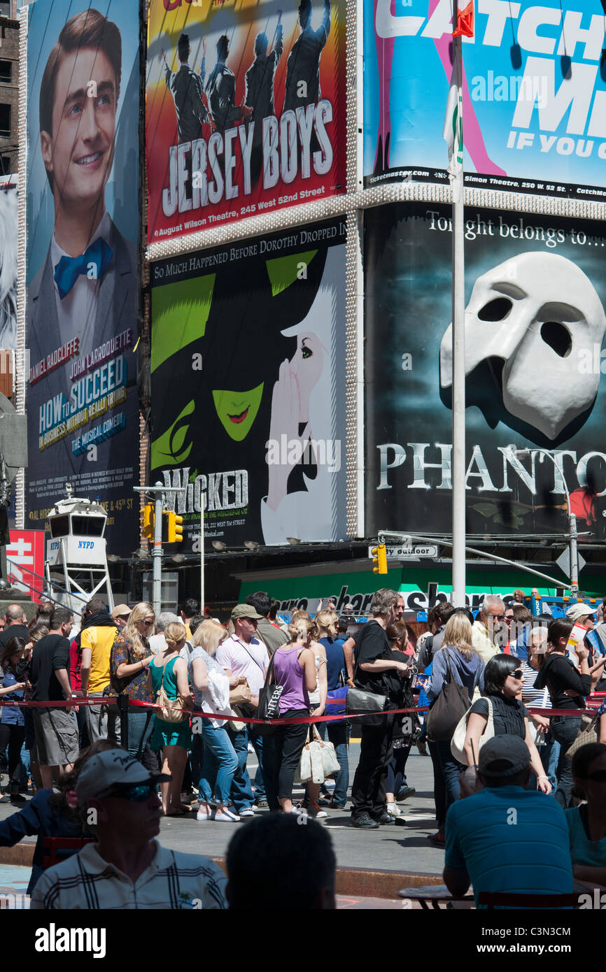 Advertising for Broadway shows and the line for TKTS half-price tickets is seen in Times Square in New York Stock Photo