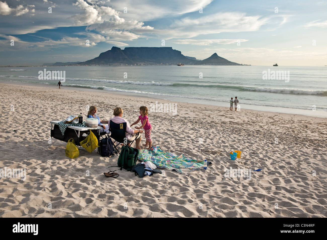 South Africa, Cape Town, Blouberg beach. Family on the beach. Background: Table mountain. Stock Photo