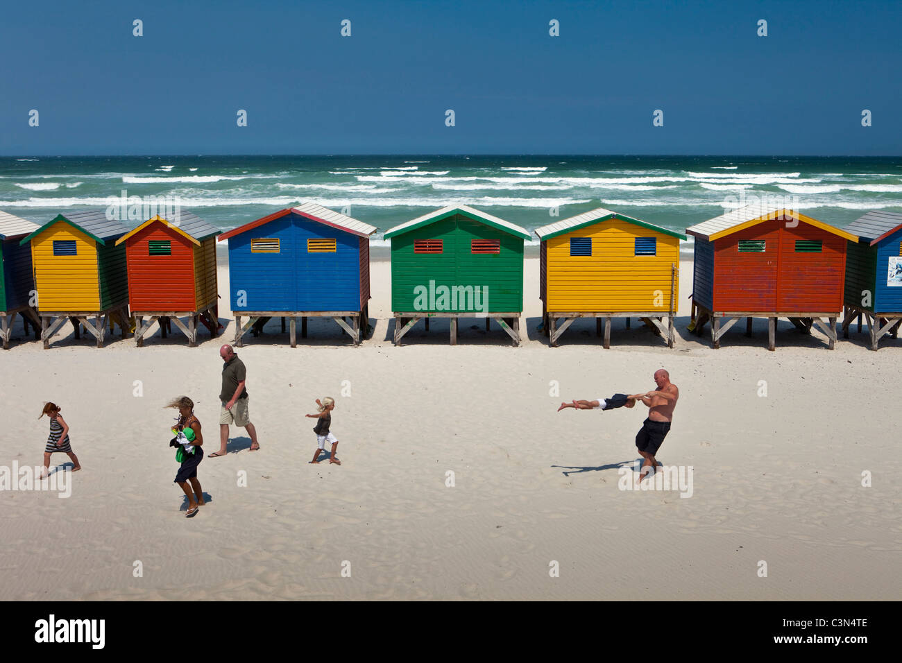 South Africa, Western Cape, Muizenberg, beach huts and family. Stock Photo
