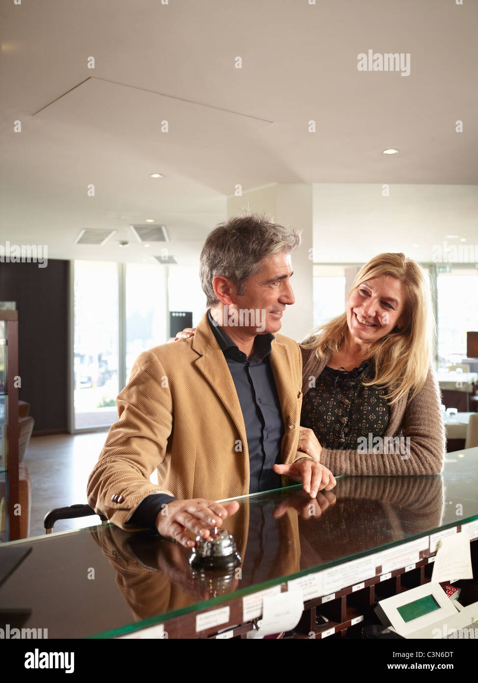Senior Couple ringing the reception bell in a Hotel Stock Photo - Alamy