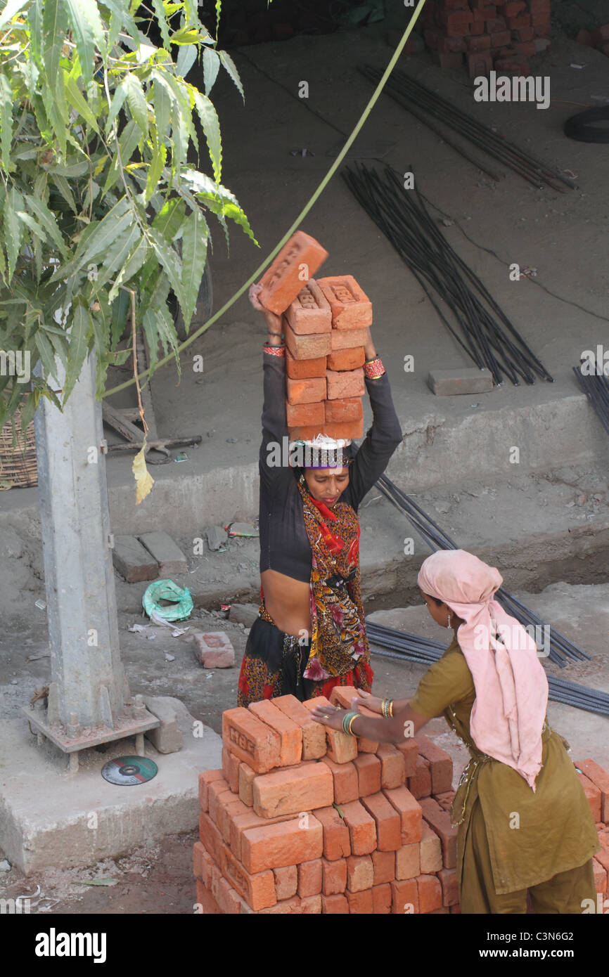 Carrying bricks on head hires stock photography and images Alamy