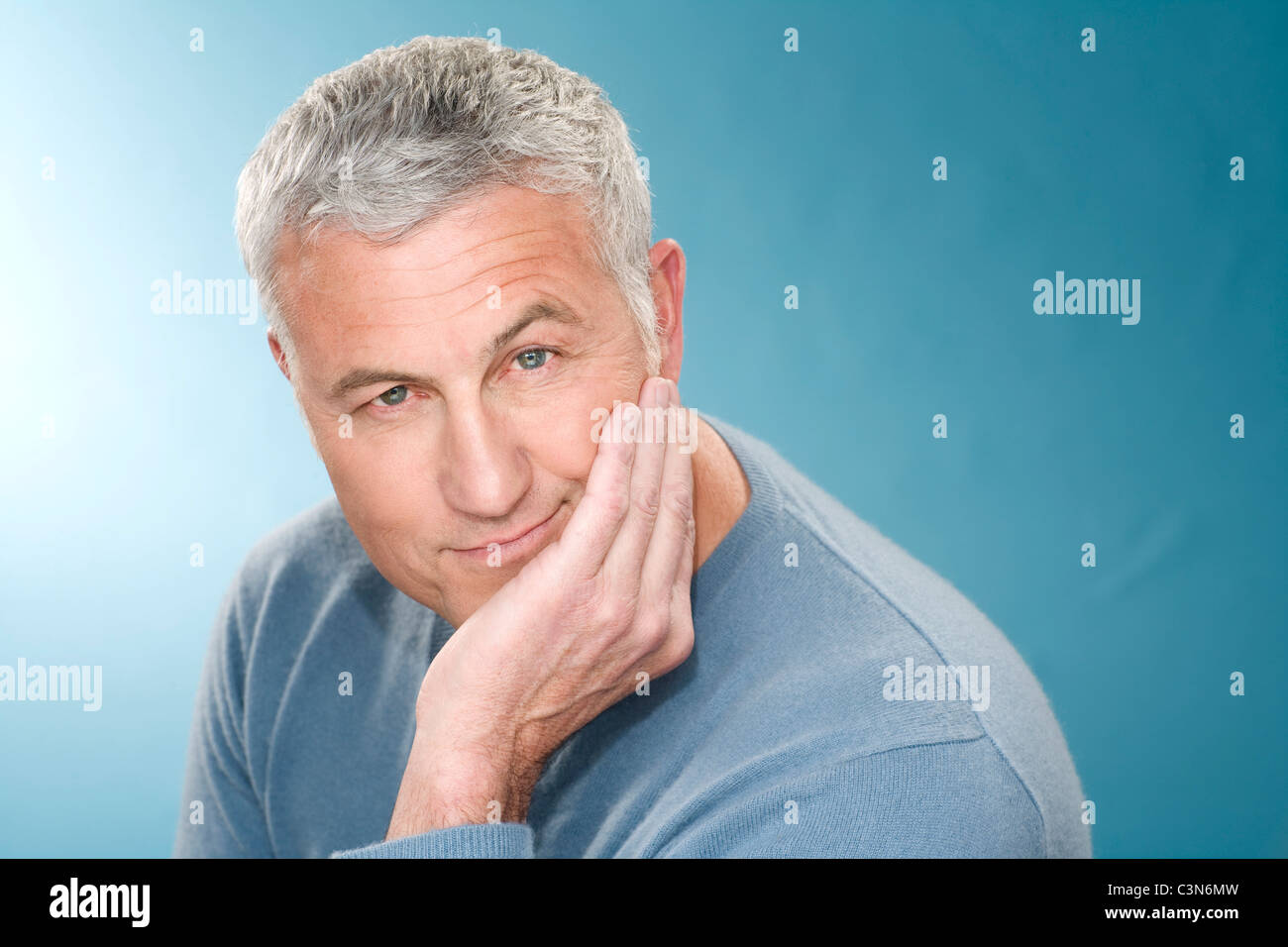 Grey hair man with head rest in hand Stock Photo - Alamy