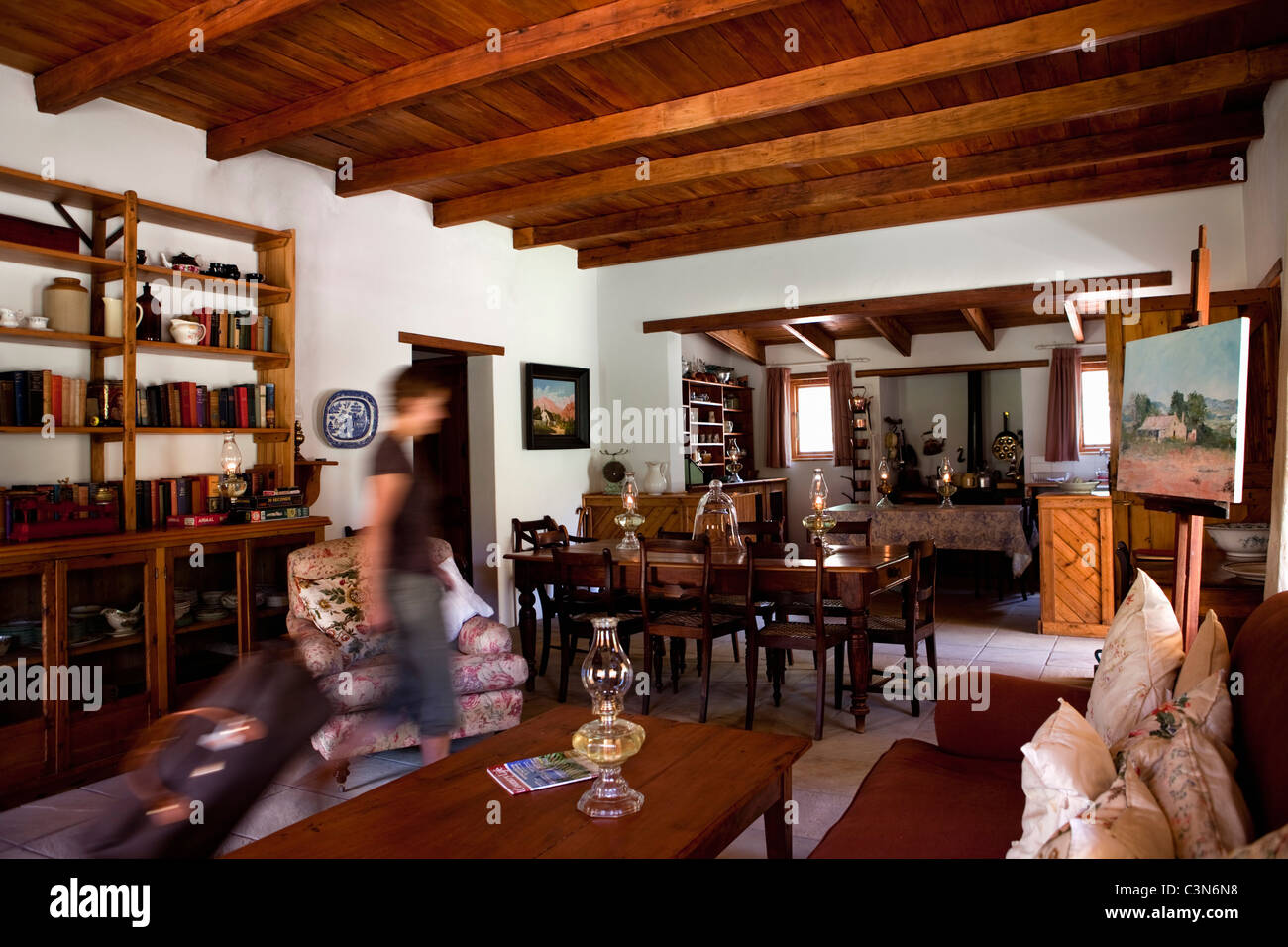 South Africa, Western Cape, Prince Albert, Guest farm Weltevrede. Guest entering living room with suitecase. Stock Photo