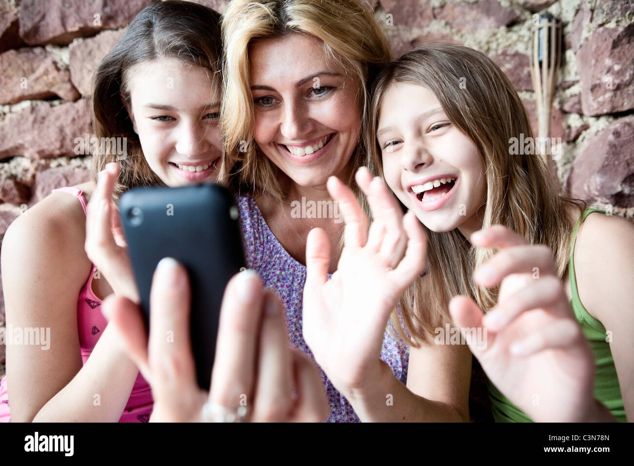 Mother and daughters video call on phone Stock Photo