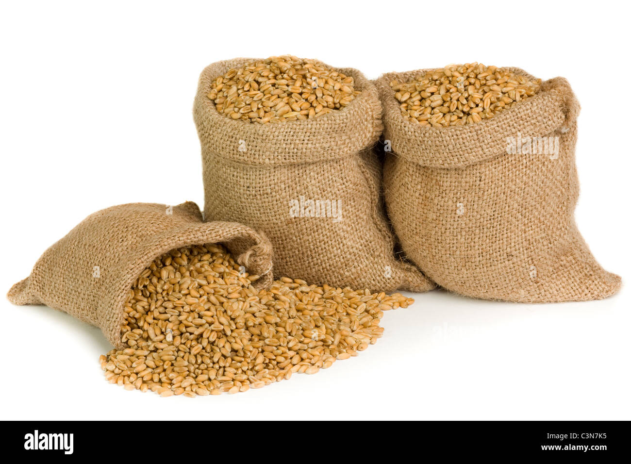 Wheat in small burlap sacks Stock Photo