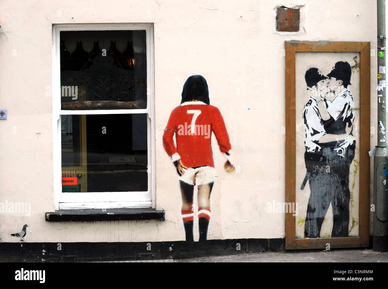 Banksy graffiti on the wall of the Prince Albert Pub in Brighton, the kissing policemen is a copy as the original has been sold Stock Photo