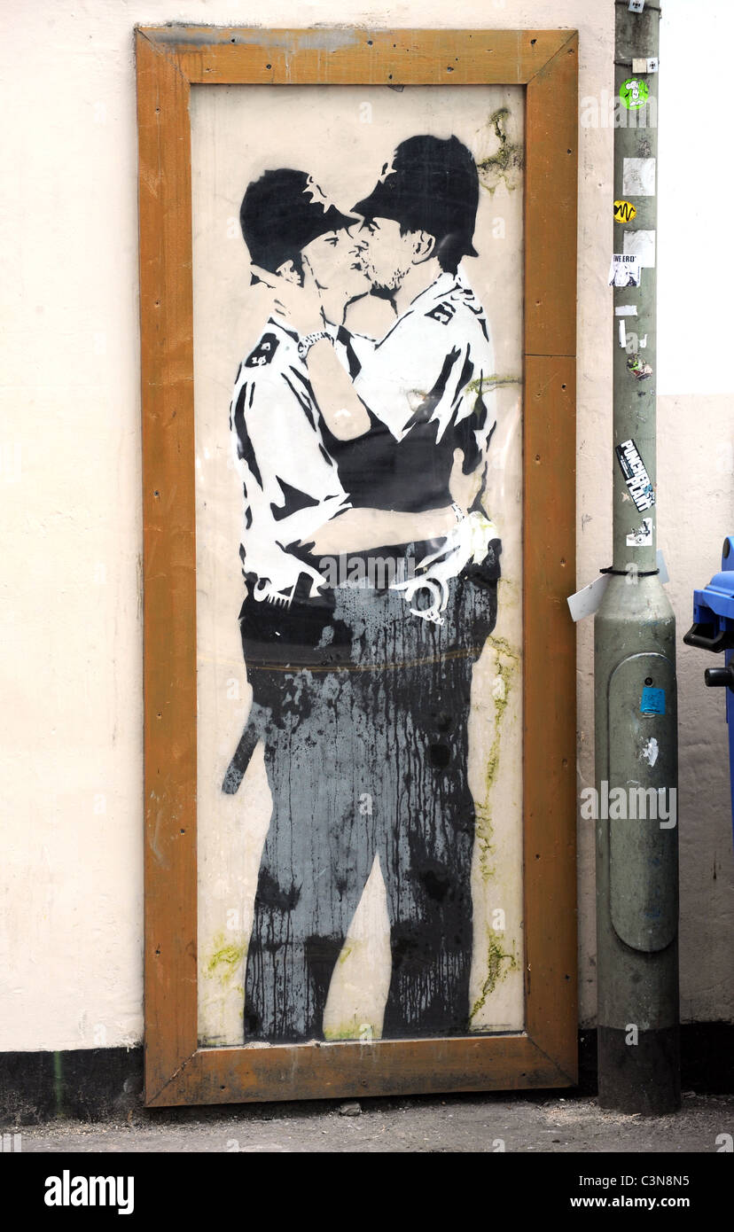 Banksy graffiti on the wall of the Prince Albert Pub in Brighton, the kissing policemen is a copy as the original has been sold Stock Photo