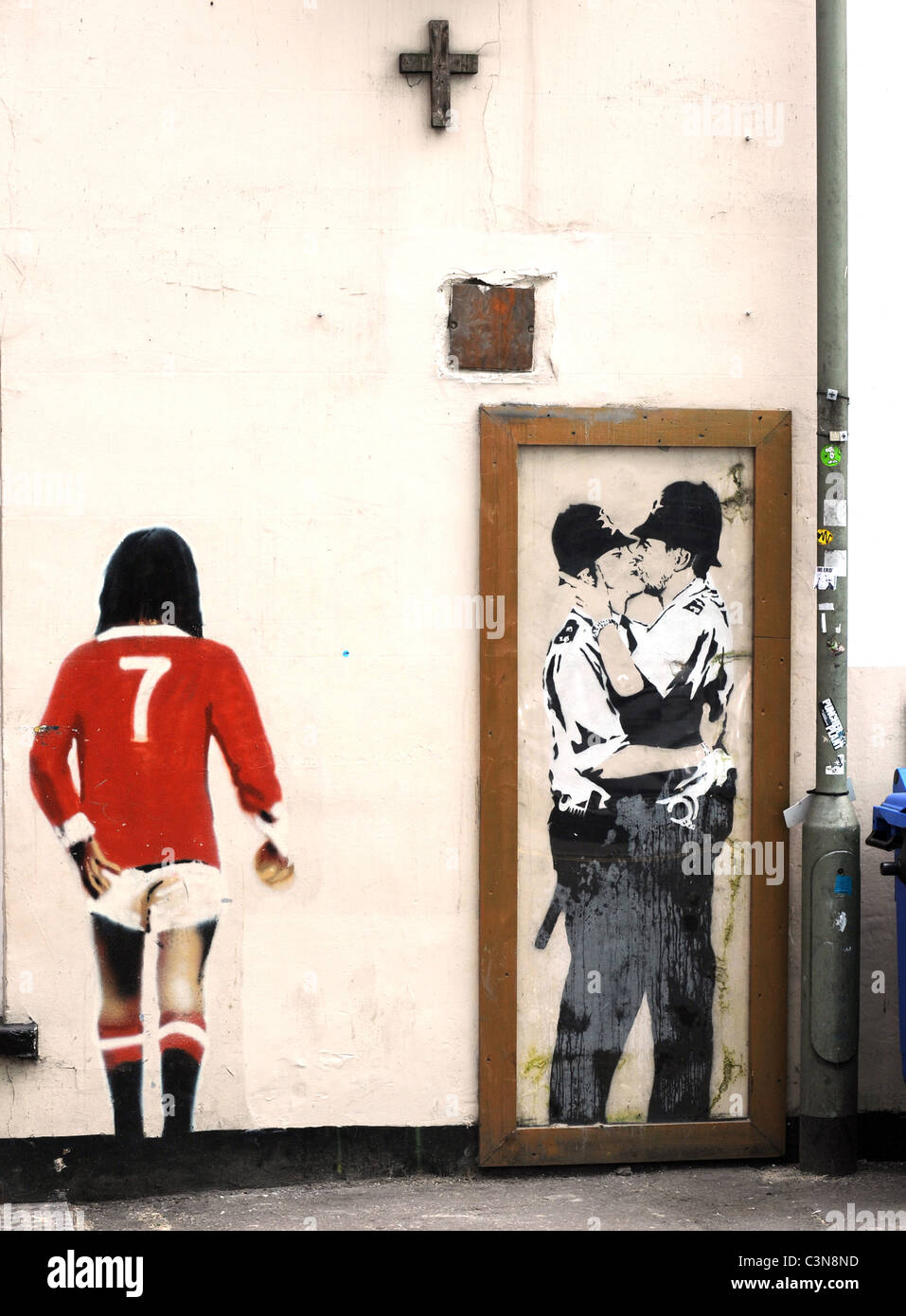 Banksy graffiti on the wall of the Prince Albert Pub in Brighton, the kissing policemen is a copy as the original has been sold Stock Photo