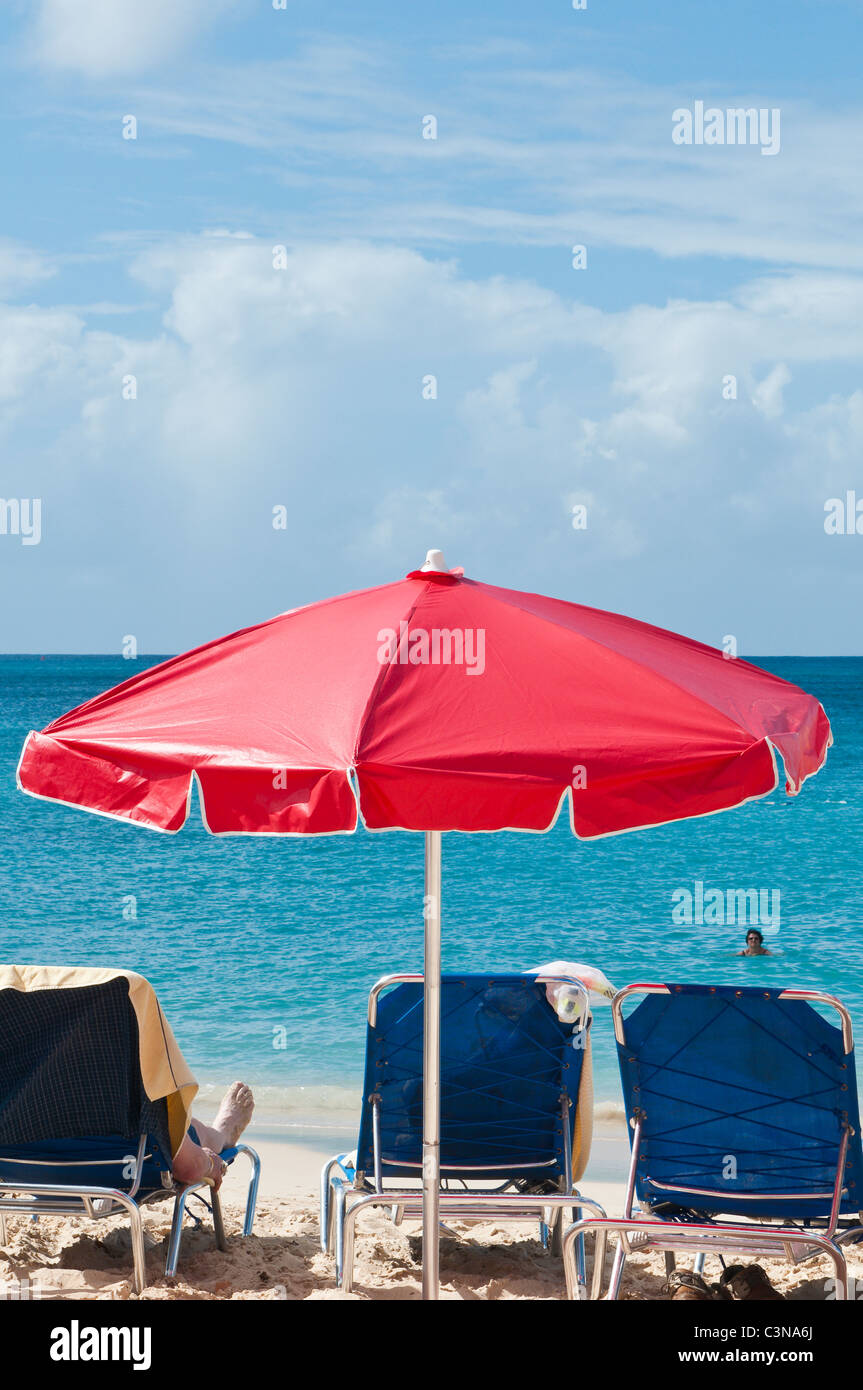 Beach umbrellas chairs people sunning sun tanning Brighton Beach or