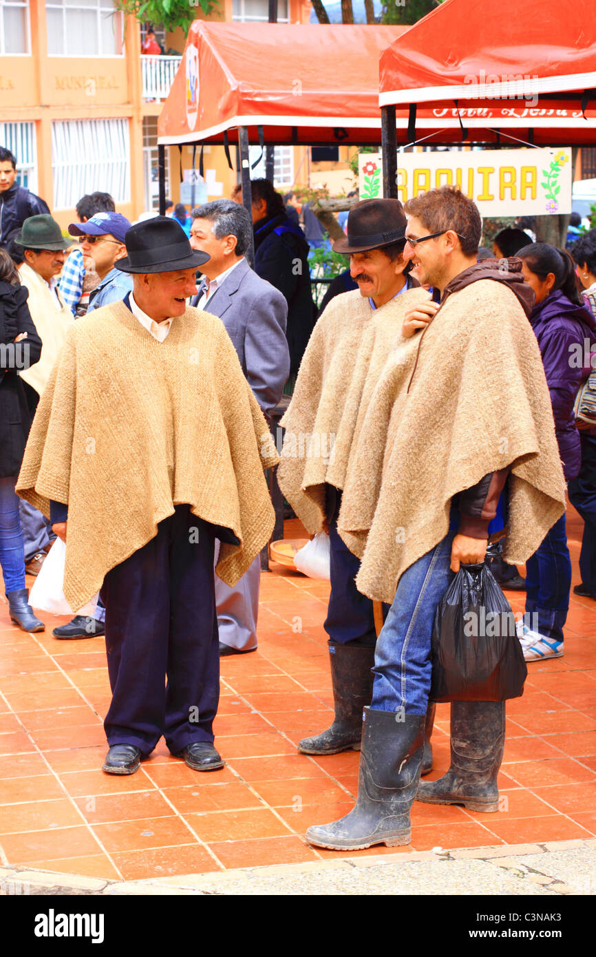 Three men talking wearing the traditional colombian poncho, called 'ruana', Toca, Boyaca, Colombia, South America Stock Photo