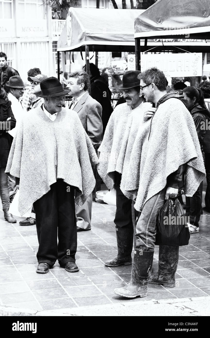 Three men talking wearing the traditional colombian poncho, called 'ruana', Toca, Boyaca, Colombia, South America Stock Photo