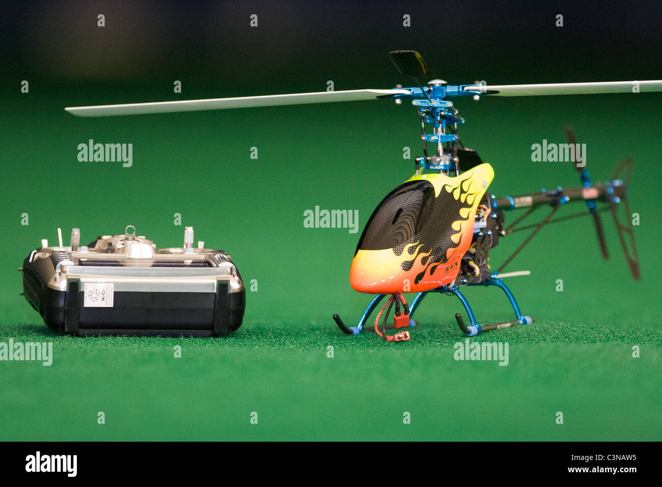Electric model helicopter and controller awaiting pilot. Helicopter is