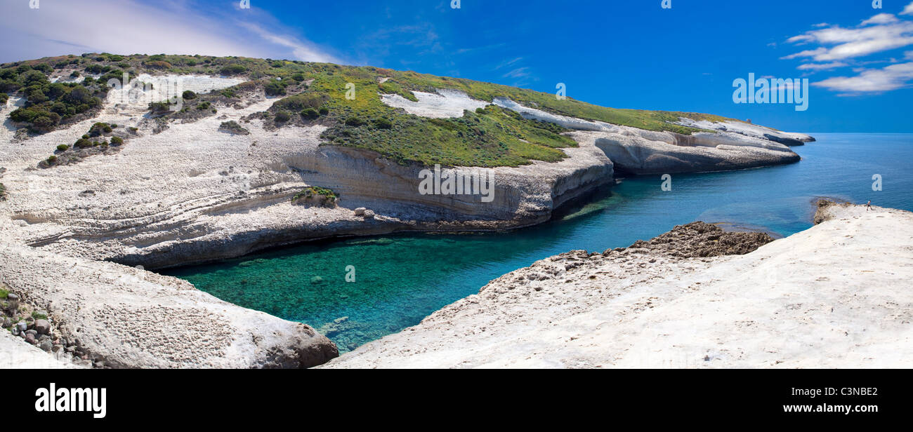 white chalk cliffs eroded coastline blue sky and sea at Caterina di Pittinuri Sardinia Italy panorama landscape Stock Photo