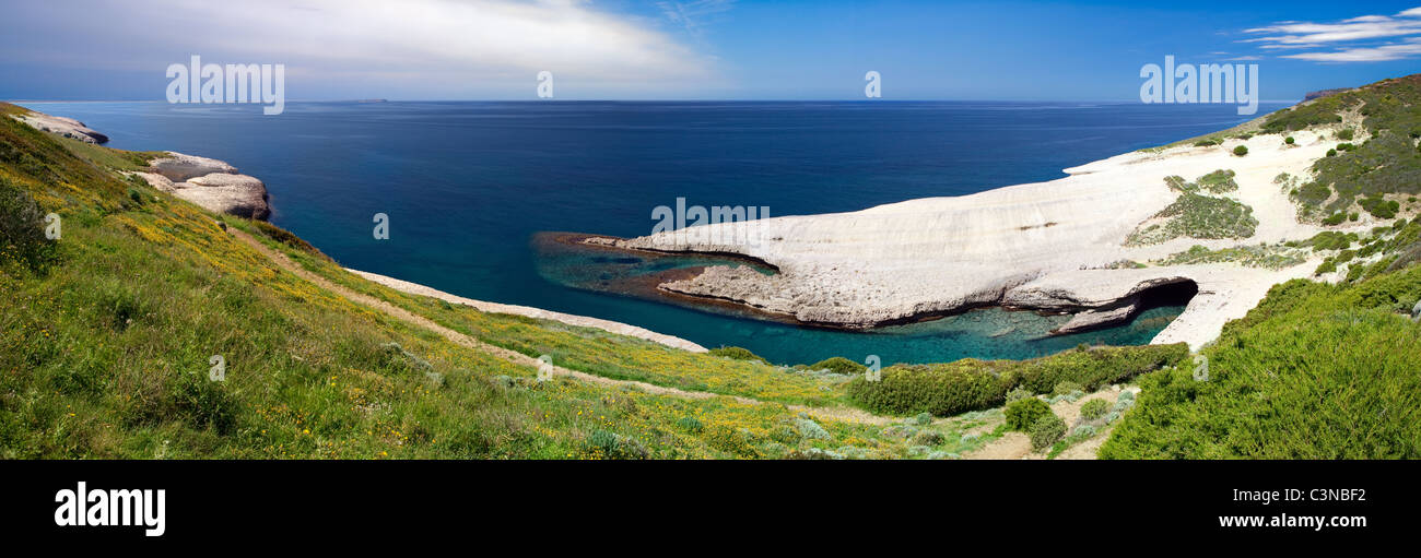 white chalk cliffs eroded coastline blue sky and sea at Caterina di Pittinuri Sardinia Italy panorama landscape Stock Photo