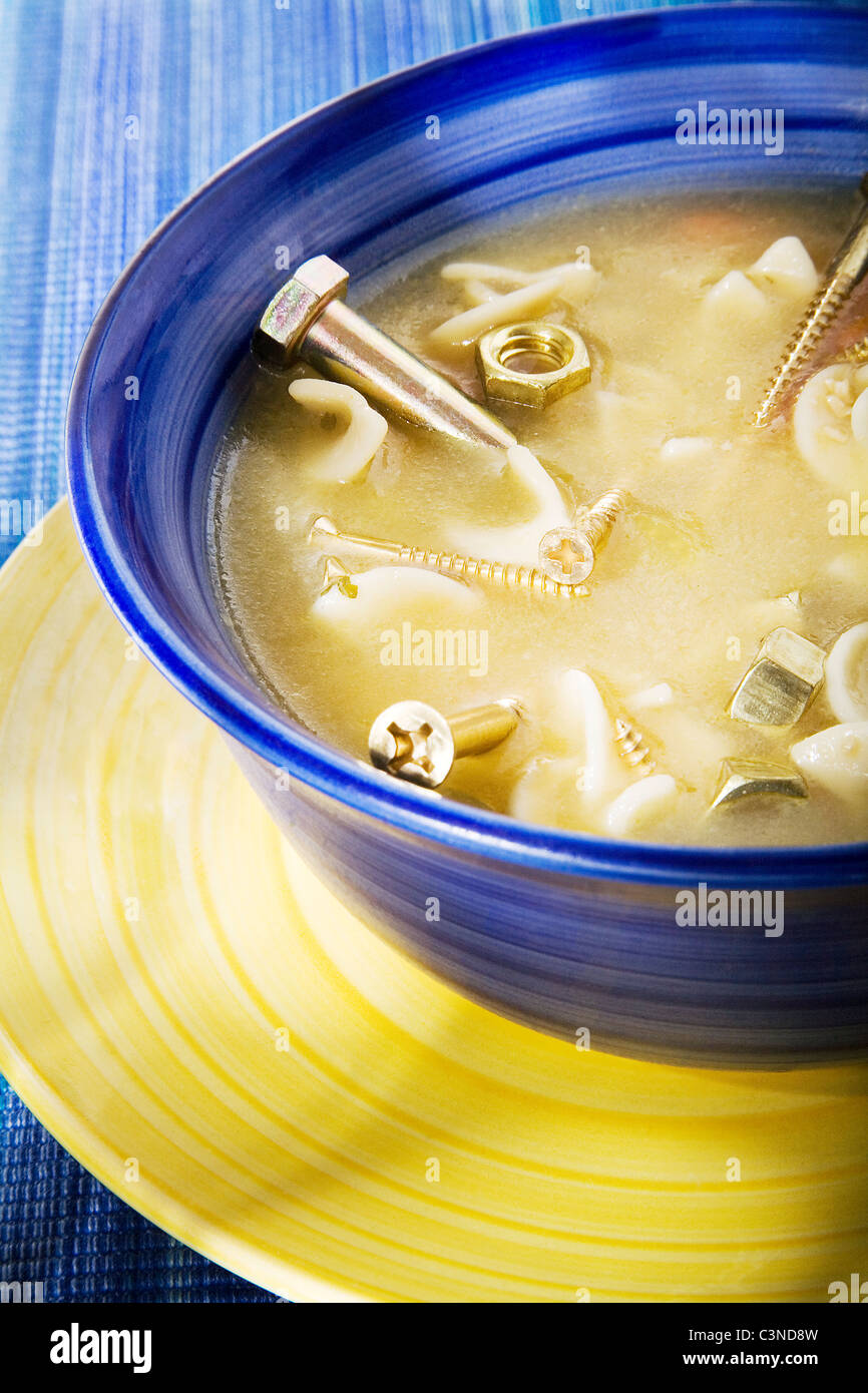 Bowl of soup with nails in it Stock Photo Alamy