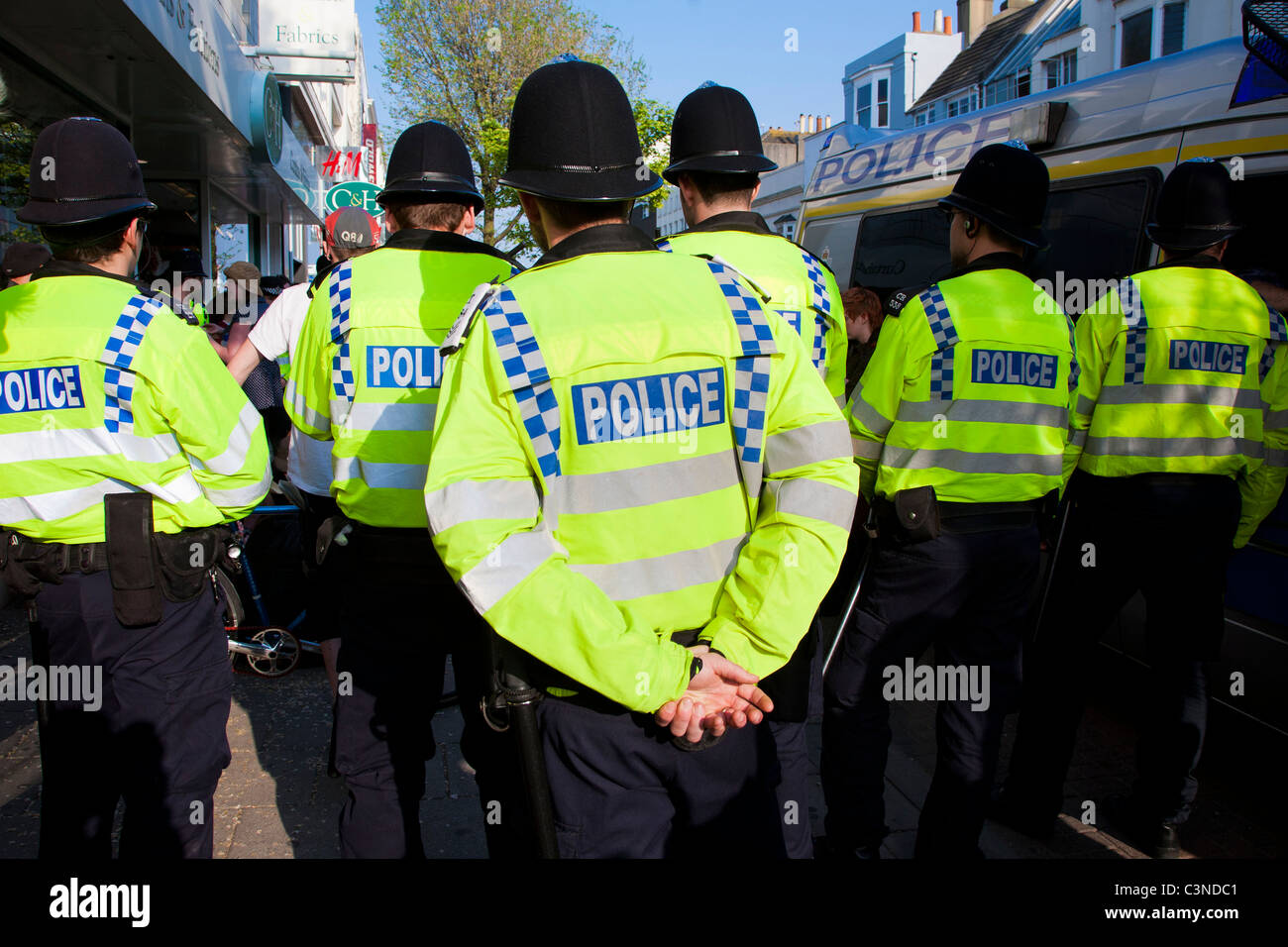 Police surround a group of protesters on the street outside Topshop in Brighton, UK Stock Photo