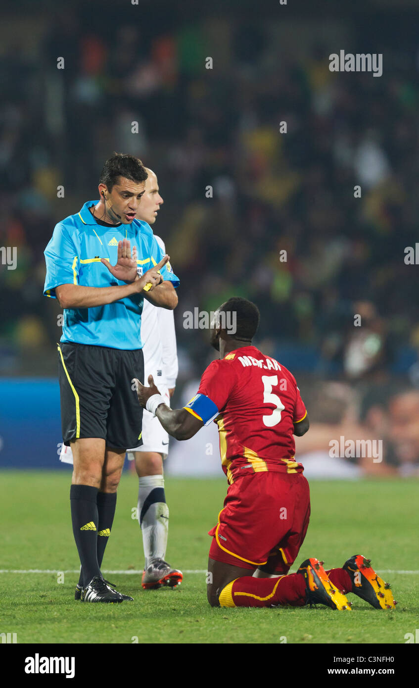 Referee Viktor Kassai cautions Ghana team captain John Mensah during a FIFA World Cup match between Ghana and the USA. Stock Photo