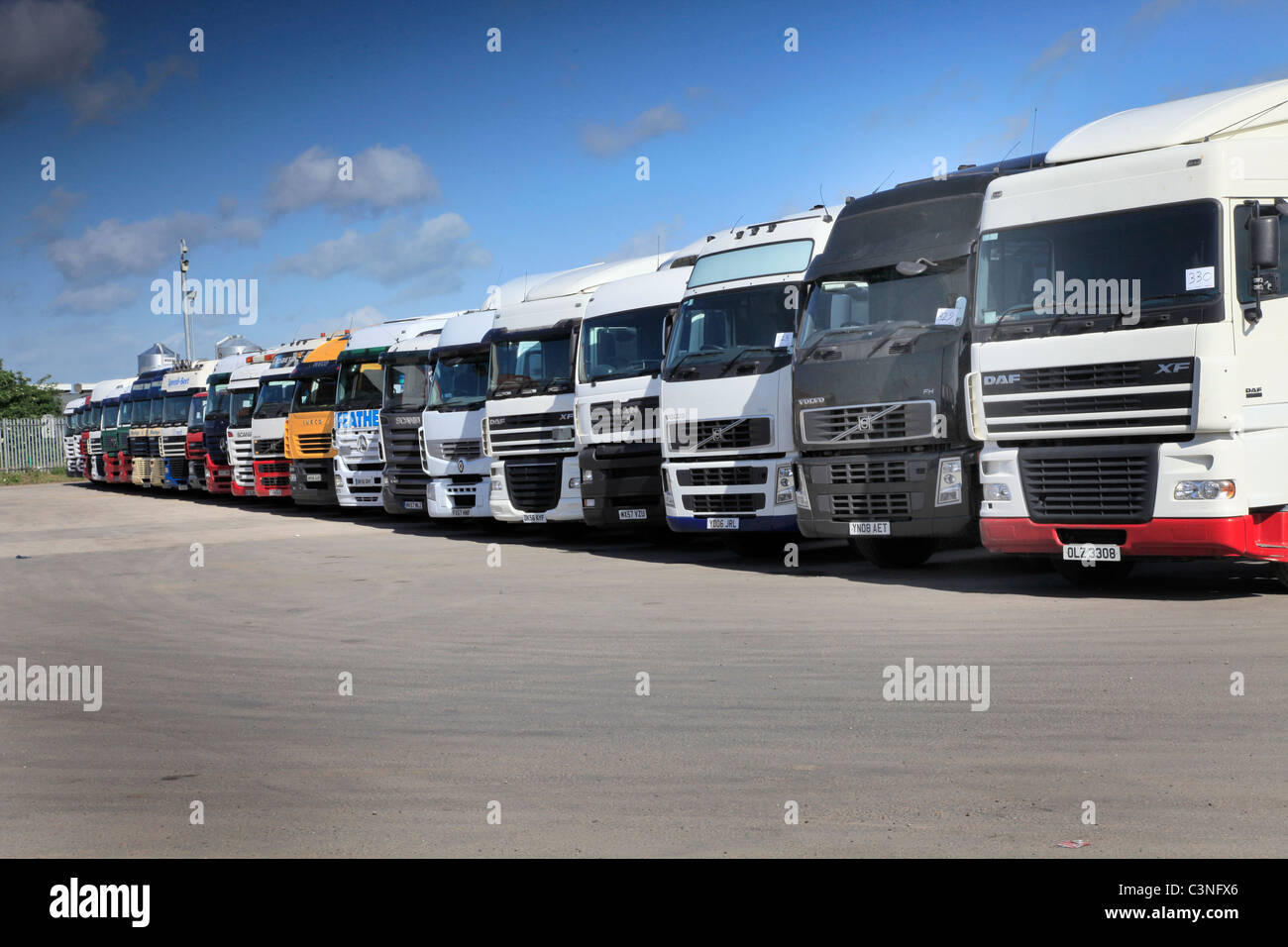 Line up of 2nd hand trucks at truck auction Stock Photo Alamy
