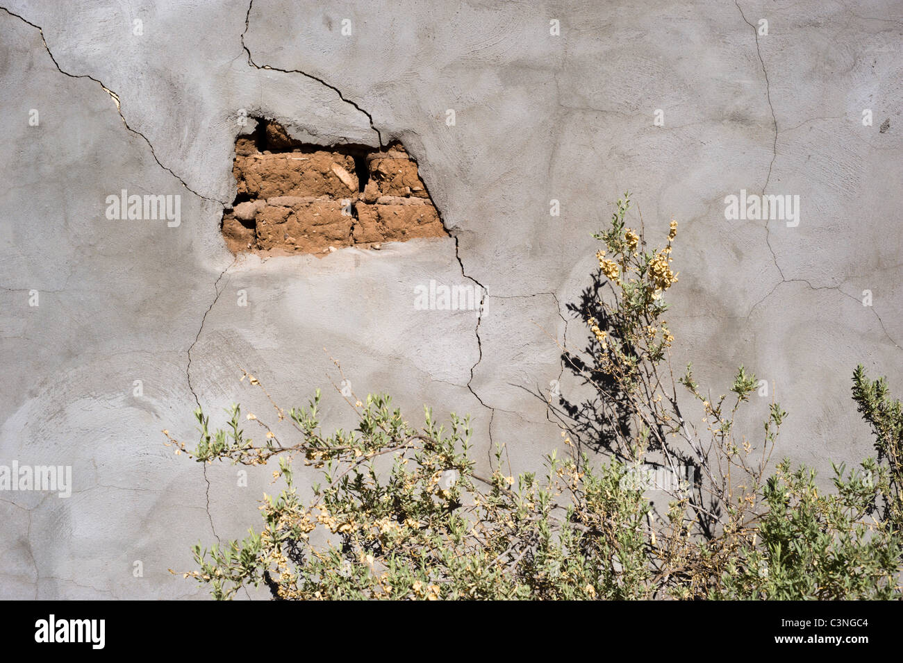 Cracking plaster reveals an old adobe wall in the Hondo Valley, Hondo, New Mexico. Stock Photo
