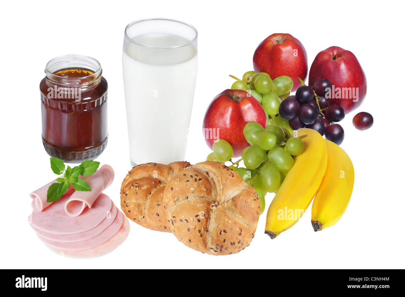 Healthy breakfast with baked goods, fruits, milk, honey and ham. Stock Photo