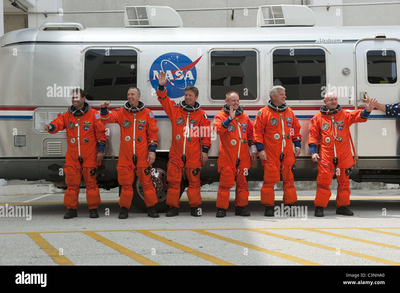Space shuttle Endeavour's astronauts in orange flight suits with Commander Mark Kelly (R). Stock Photo