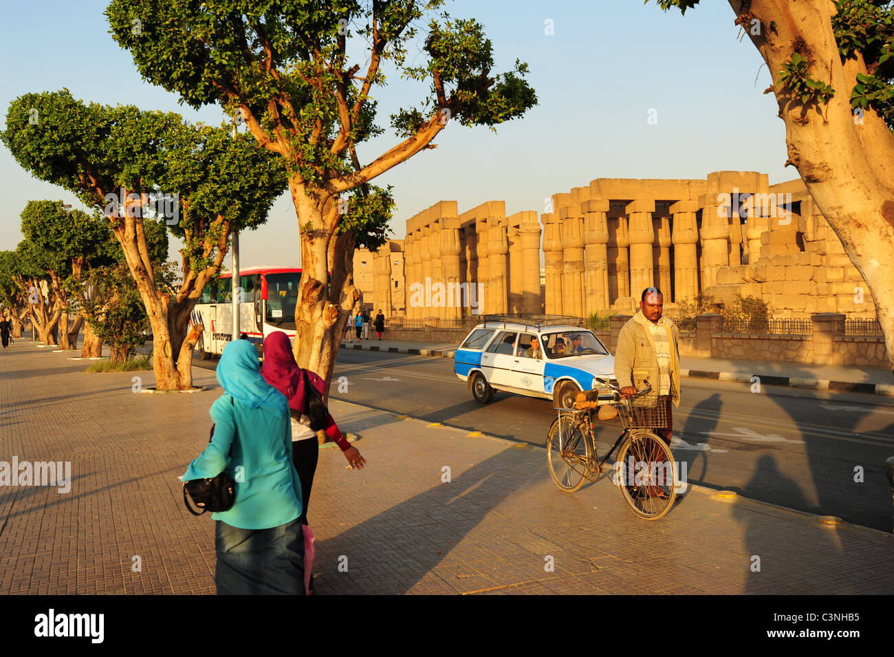 Africa Middle East Egypt Egyptian Luxor Temple of Karnak people buses and taxis pass by the ancient antiquties Stock Photo