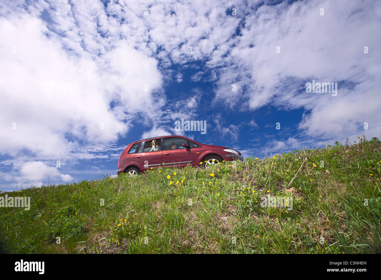 minivan on a background of cloudy sky. Stock Photo