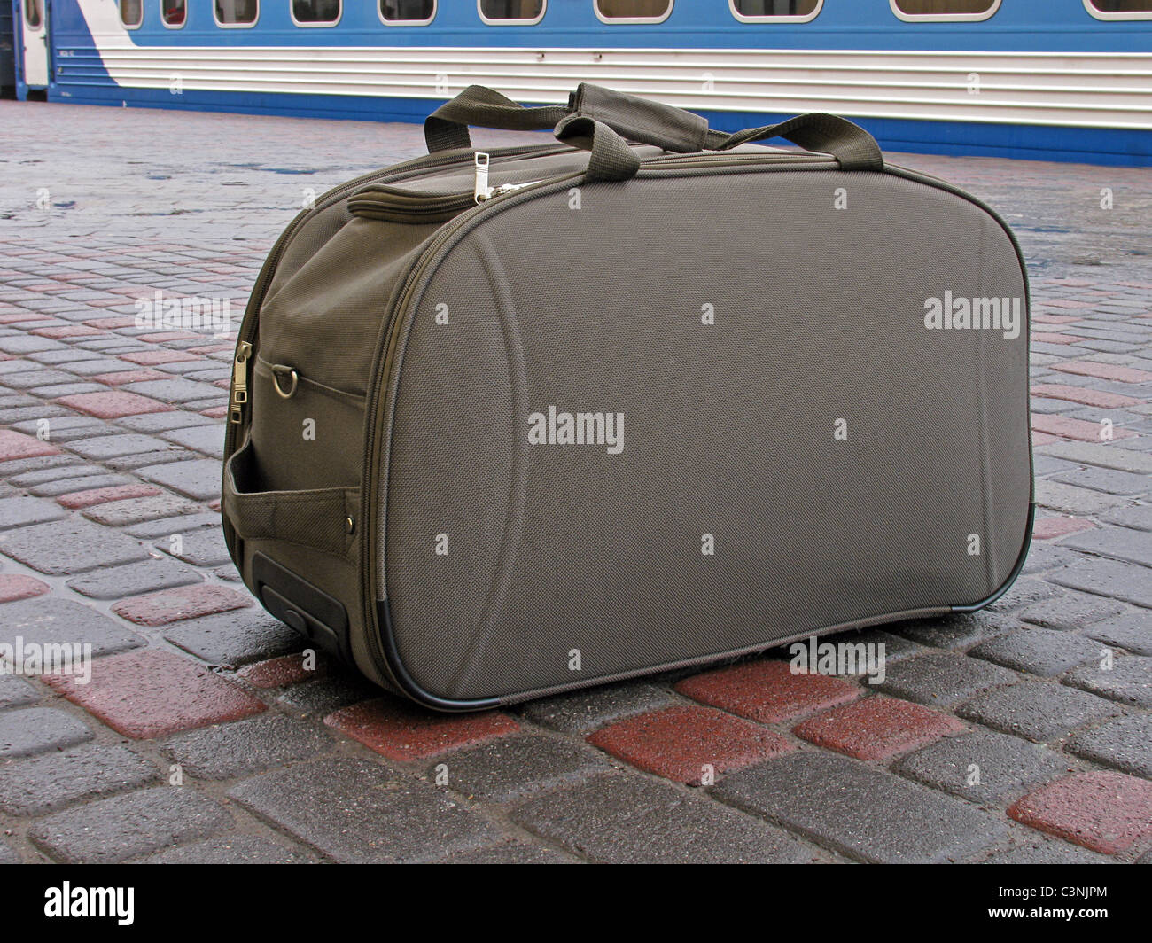 carryall standing on platform in front of train Stock Photo