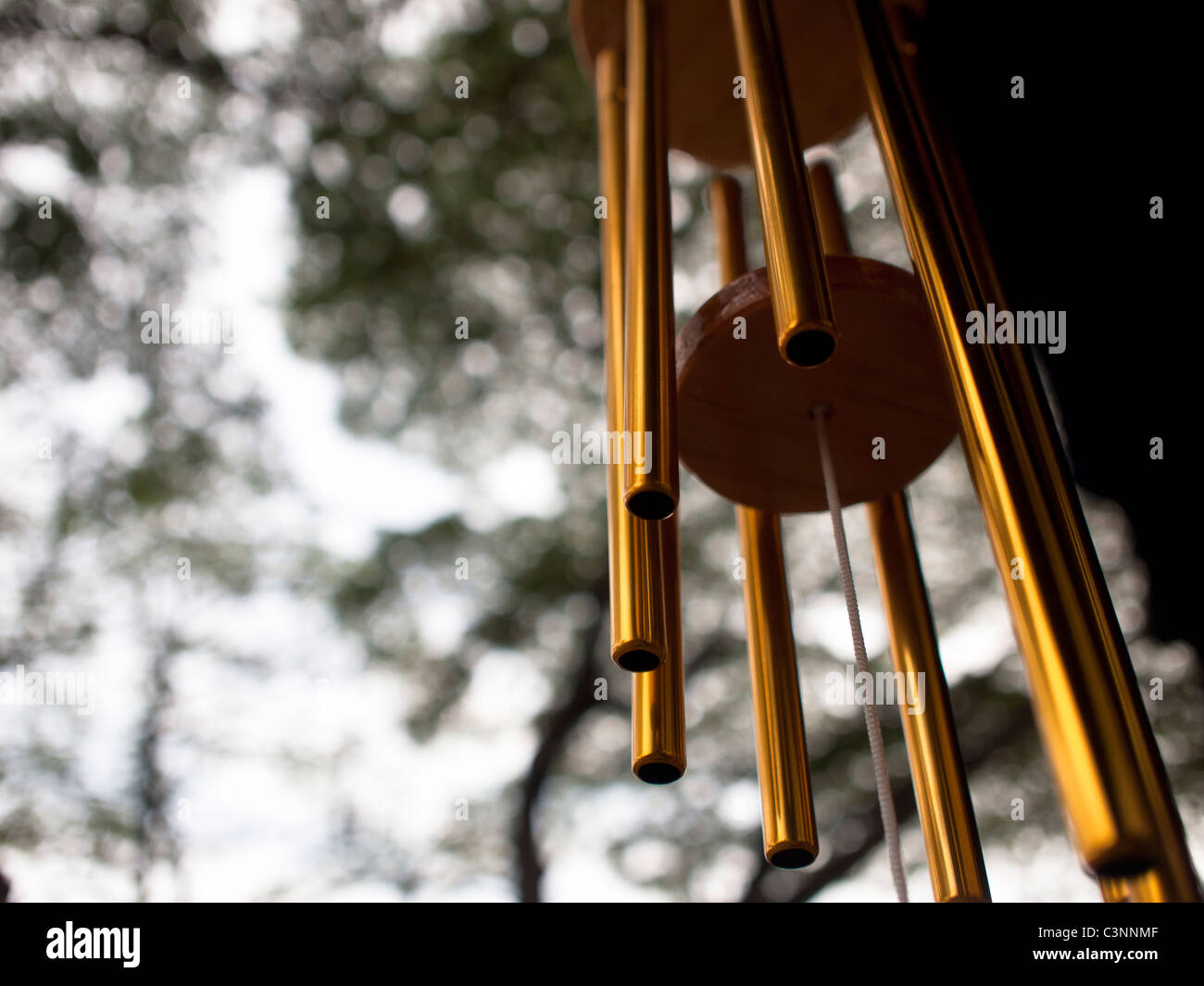 A Wind chime isolated against a natural background Stock Photo