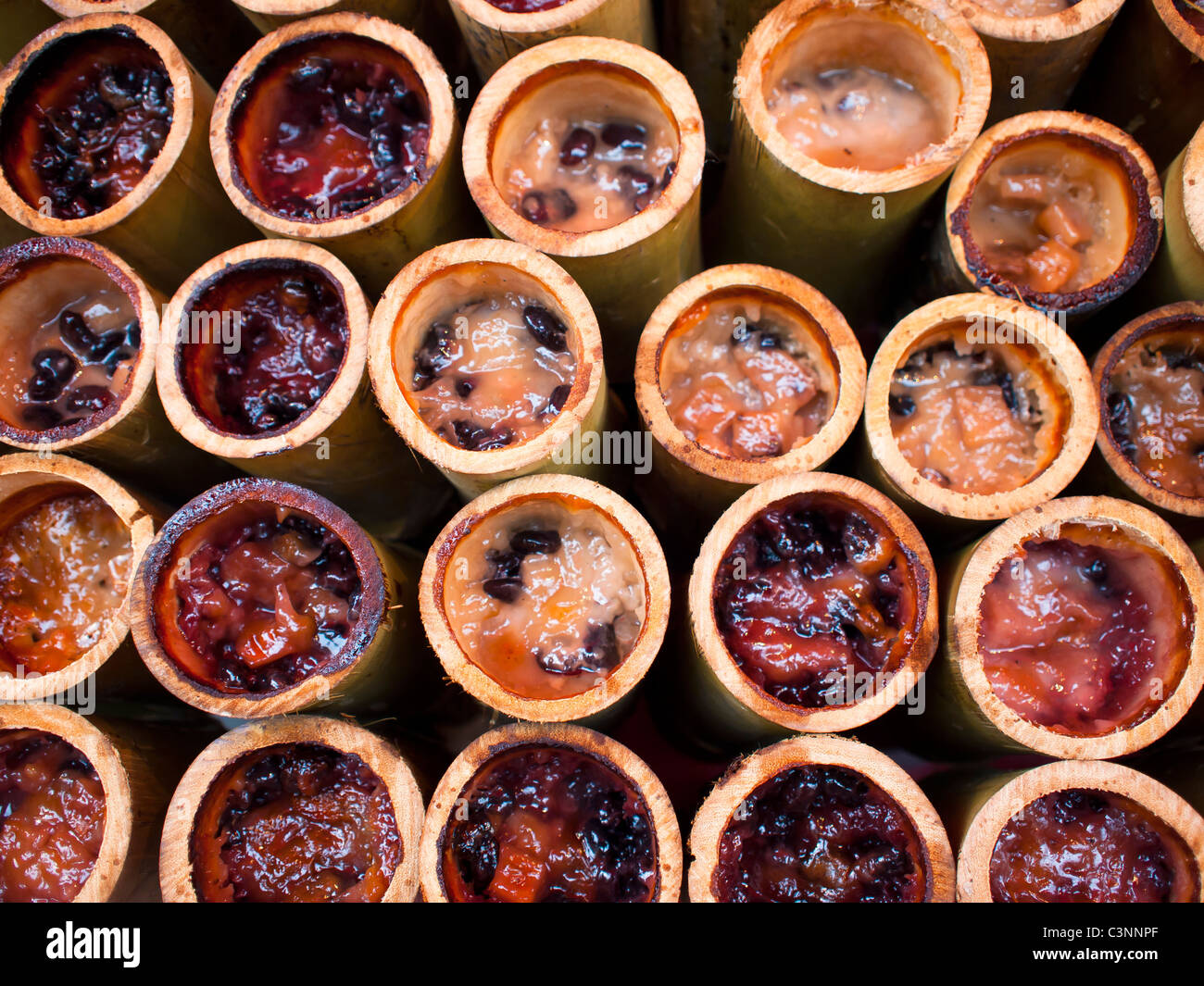 khao lam – sticky rice cooked in a bamboo tube. Stock Photo