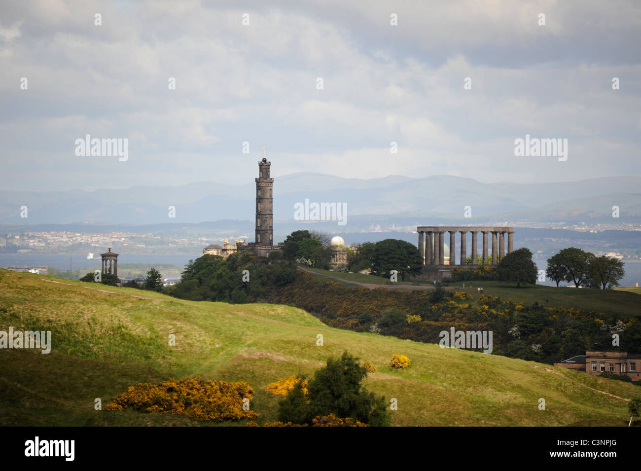 Nelson's Monument and the National Monument on Calton Hill with Salisbury Crags in the foreground in the centre of Edinburgh Stock Photo