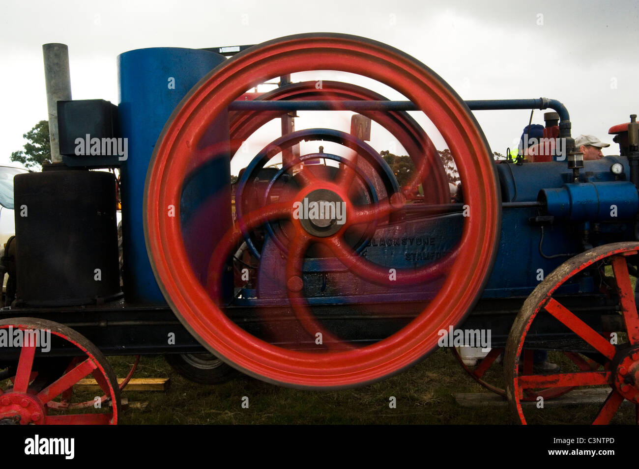 steam powered flywheel spinning Stock Photo