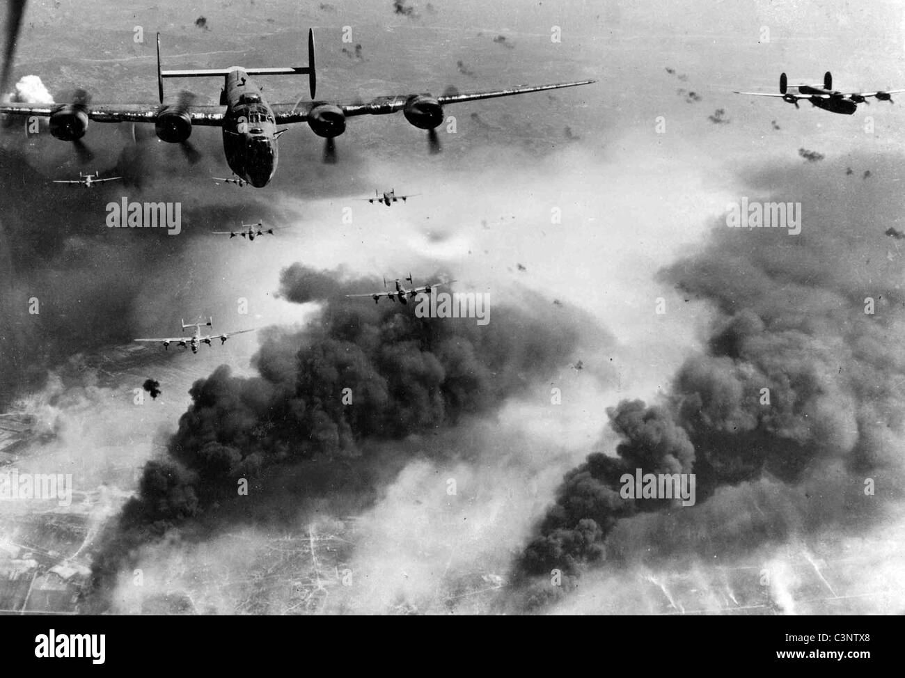 15th Air Force B-24s leave Ploesti, Romania after a bombing run. Stock Photo