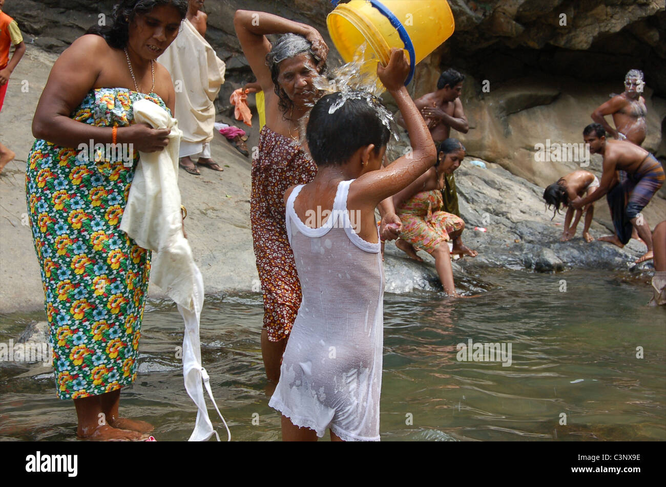 A girl washing at Rawana Ella Falls (Ravana). Stock Photo