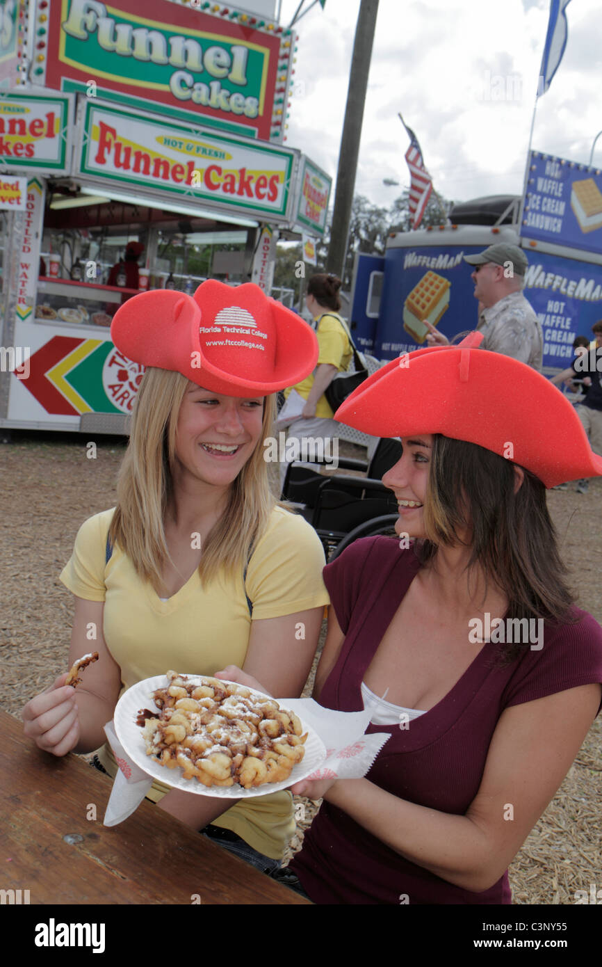 Plant City Florida,Florida Strawberry Festival,event,teen teens teenage teenager teenagers youth adolescent,girls,female,funnel cake,carnival food,vis Stock Photo
