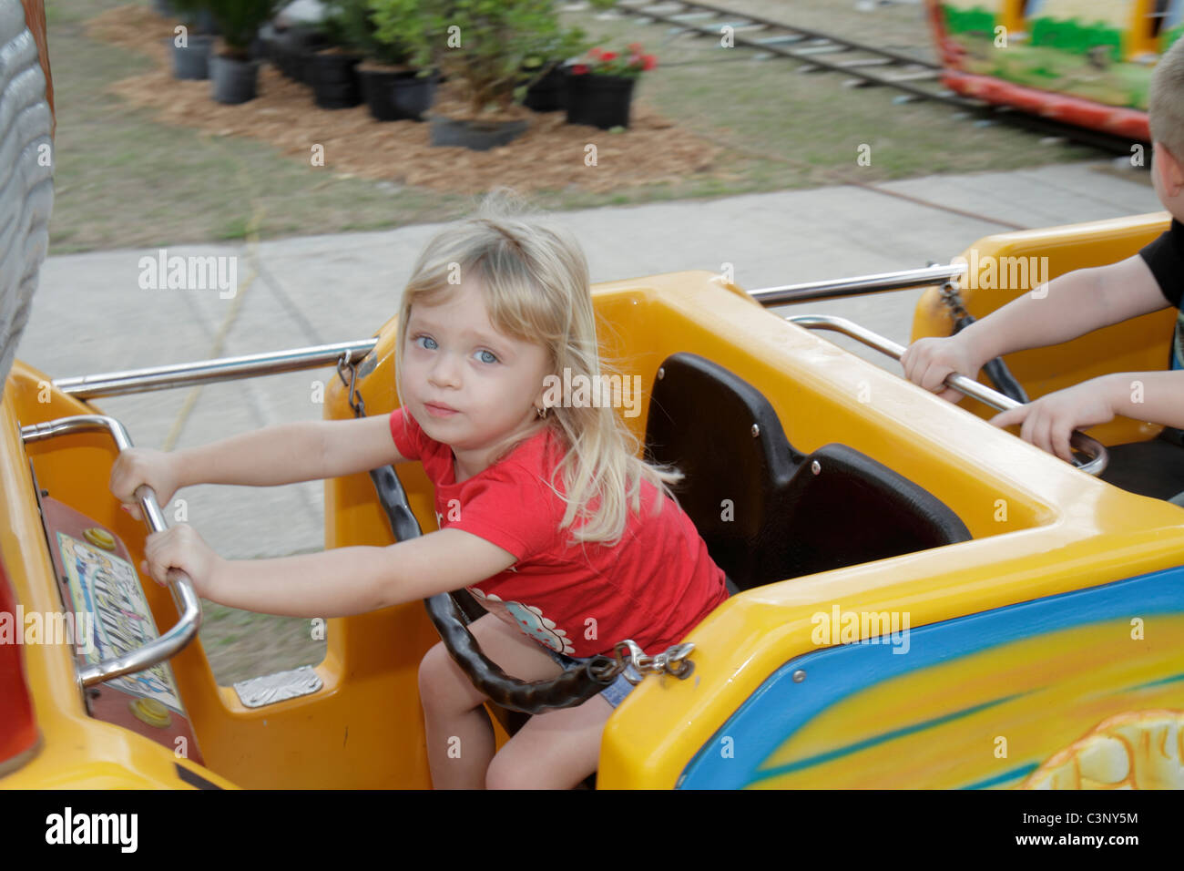 Plant City Florida,Florida Strawberry Festival,event,girl girls,youngster youngsters youth youths female kid kids child children,holding on,kiddy ride Stock Photo