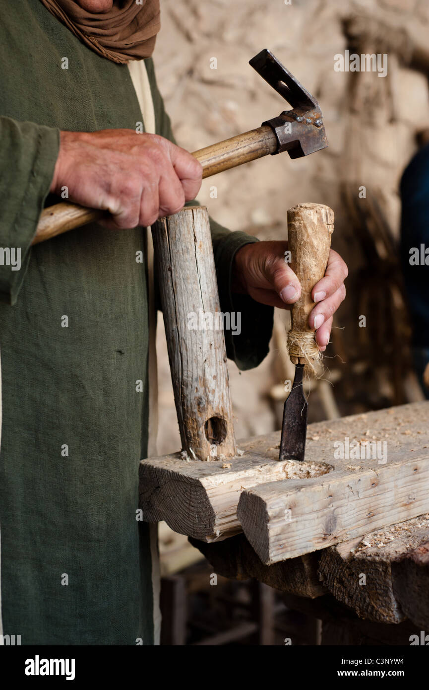 A historical re-enactor serves as a carpenter building furniture using hand tools at Nazareth Village. Stock Photo