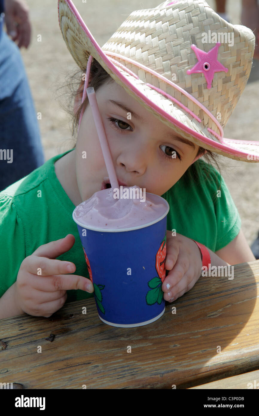 Plant City Florida,Florida Strawberry Festival,event,girl girls,youngster youngsters youth youths female kid kids child children,strawberry milkshake, Stock Photo