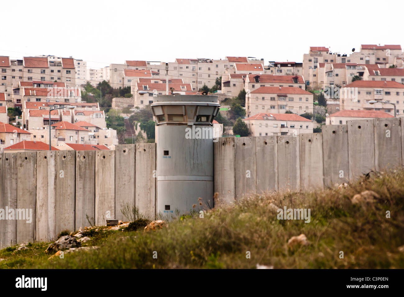 The Israeli separation wall surrounds the Jewish settlement of Pisgat Ze'ev. Stock Photo