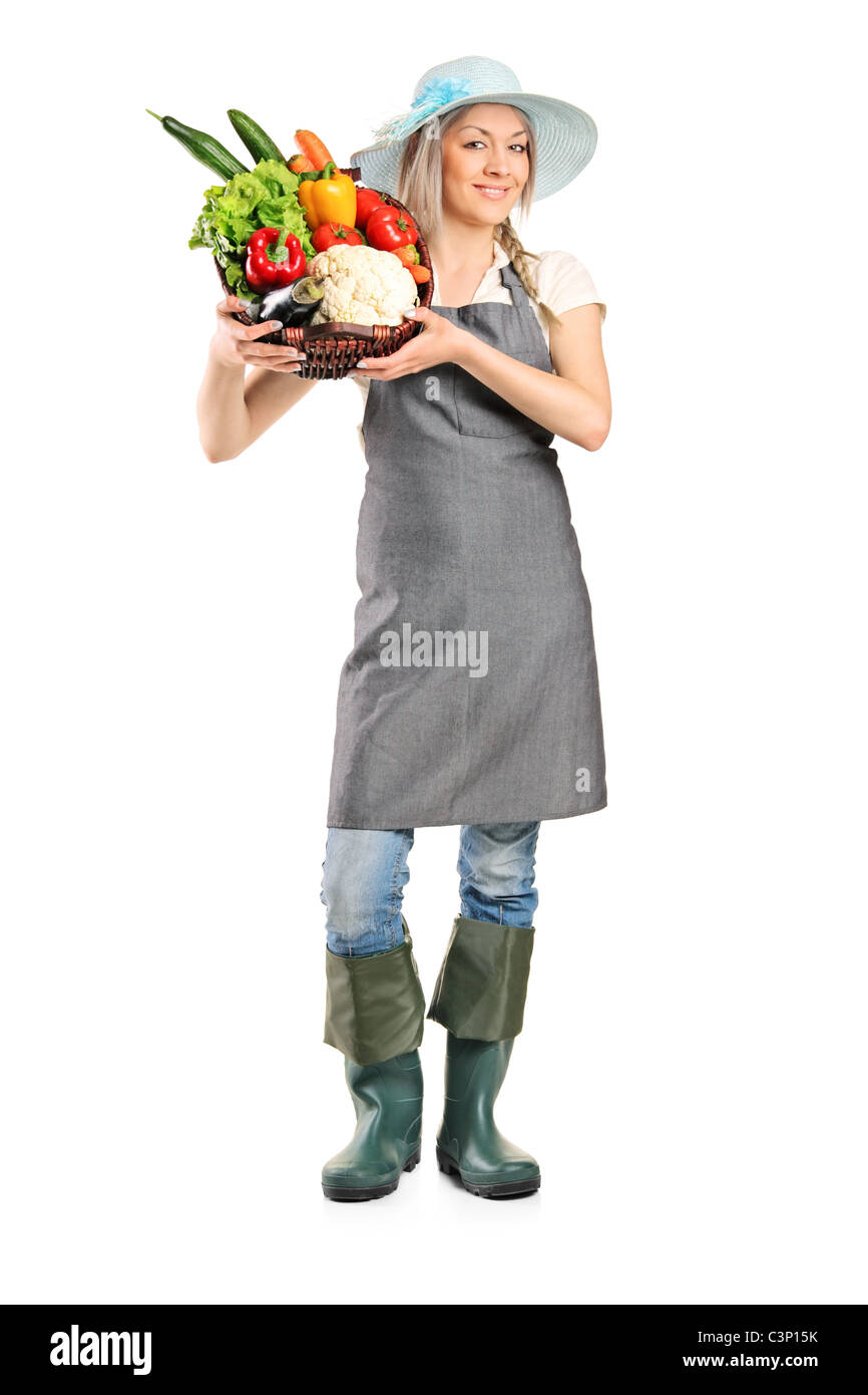 Full length portrait of a female farmer holding a basket full of ...