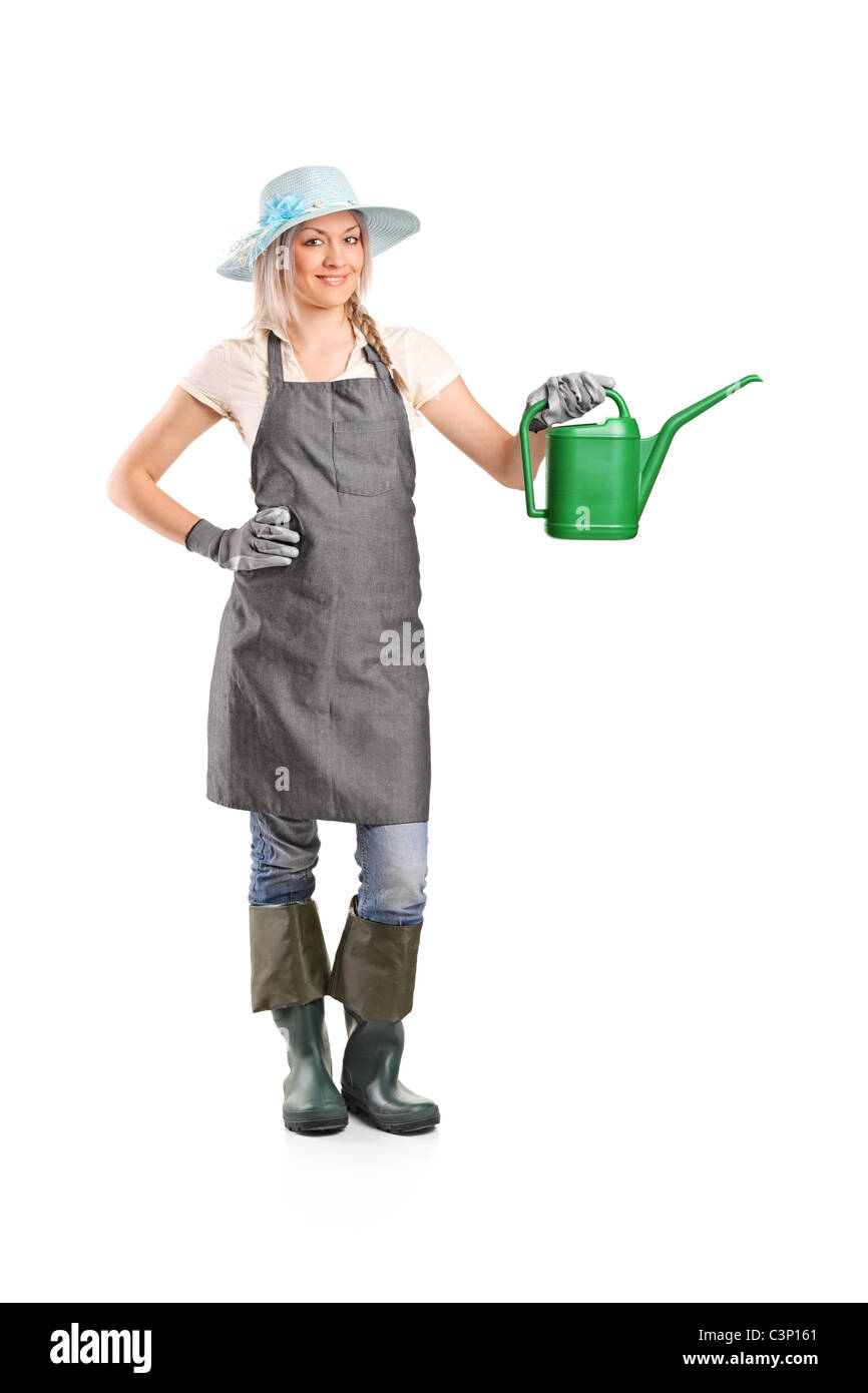 Full length portrait of a smiling female gardener with watering can ...