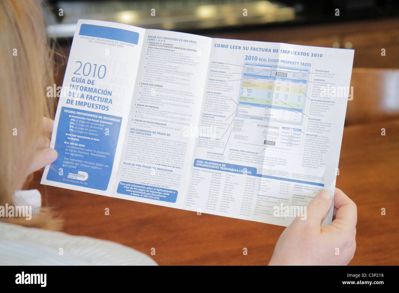 Miami Beach Florida,adult adults woman women female lady,reading,holding,county real estate tax