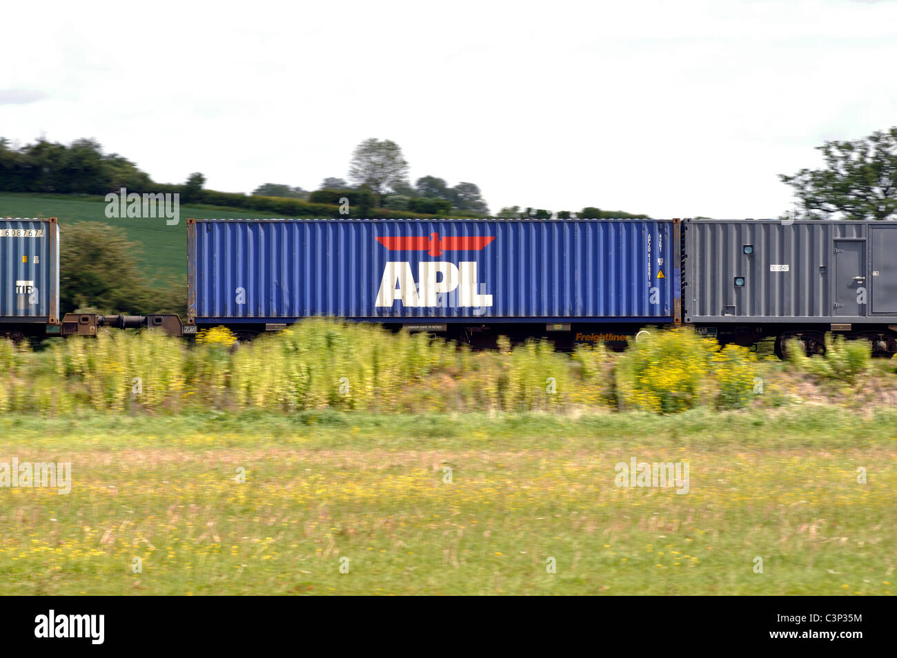 APL shipping container transported on a train Stock Photo