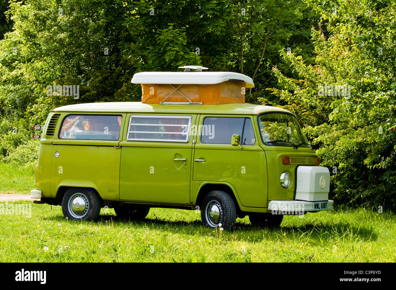 Lime green VW Camper van - parked in a field. UK. Stock Photo