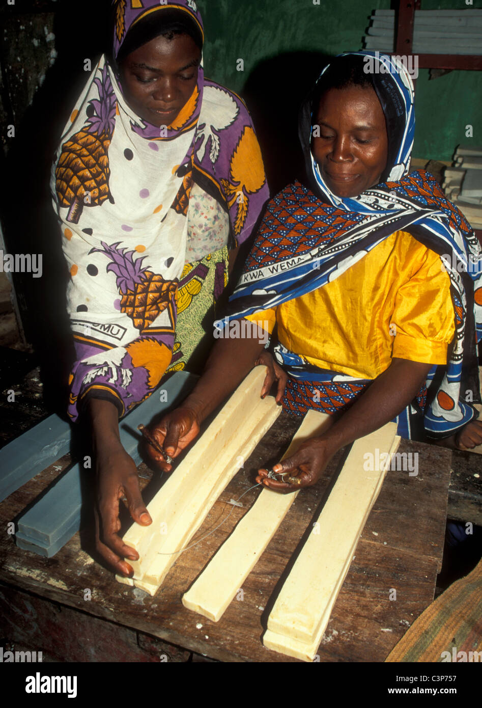 Women's cooperative, two women making soap from coconut oil, Zanzibar