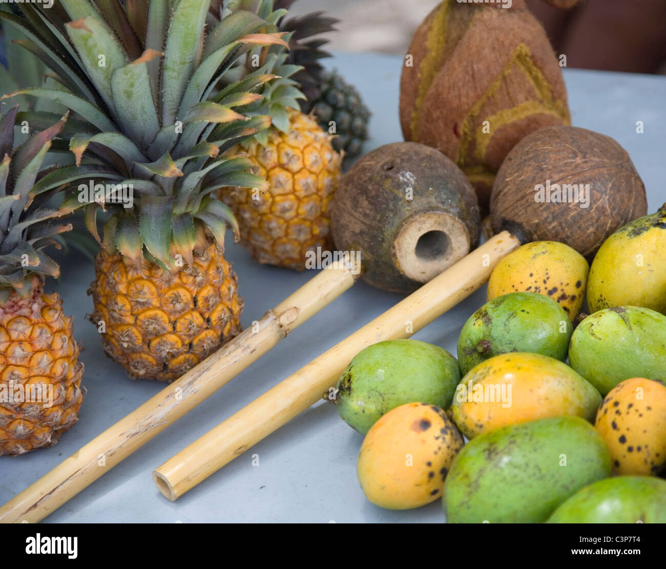 Fruit and two coconut pipes on table - Antigua Stock Photo