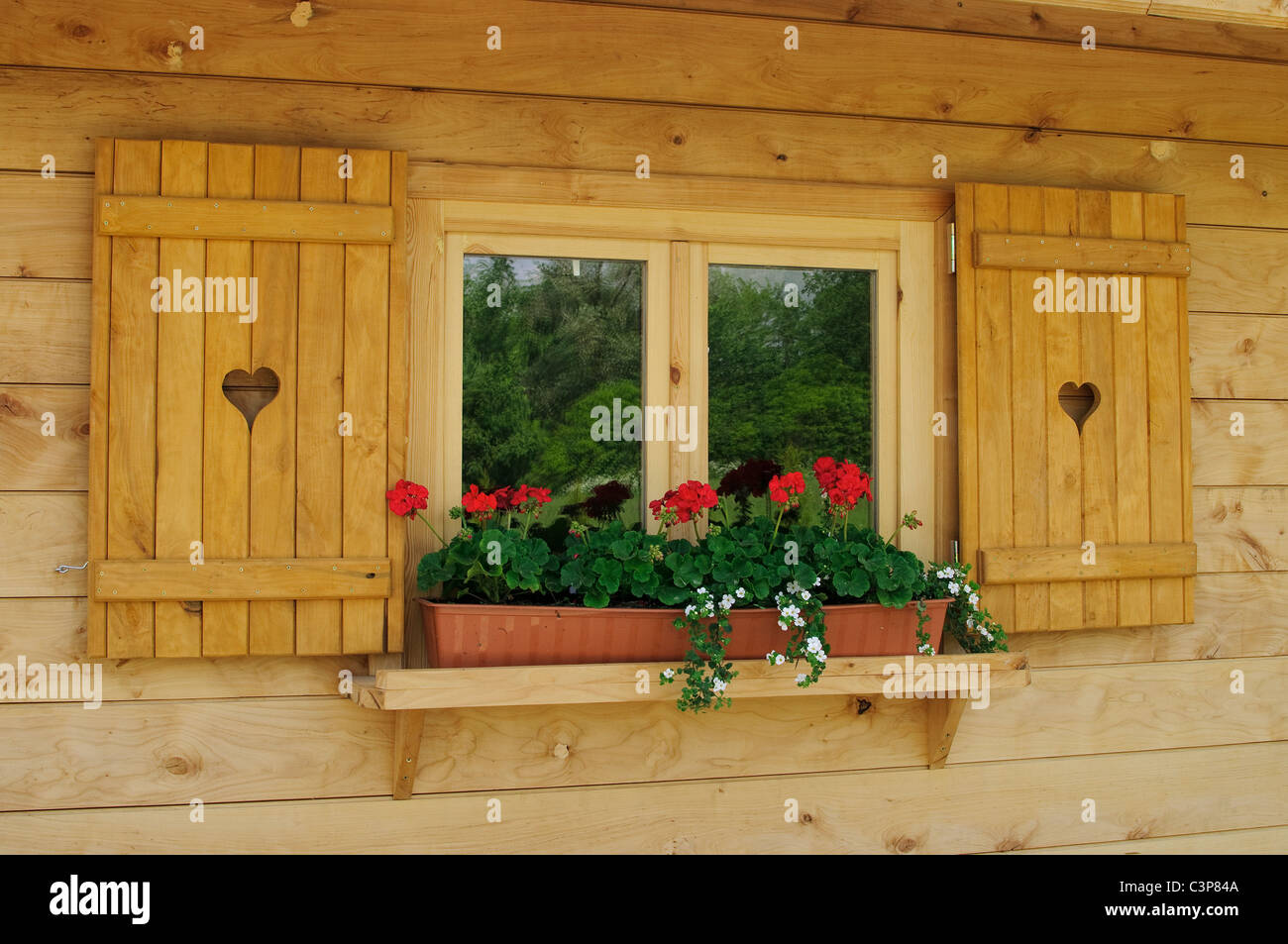 Window with a wooden frame decorated with geranium Stock Photo - Alamy
