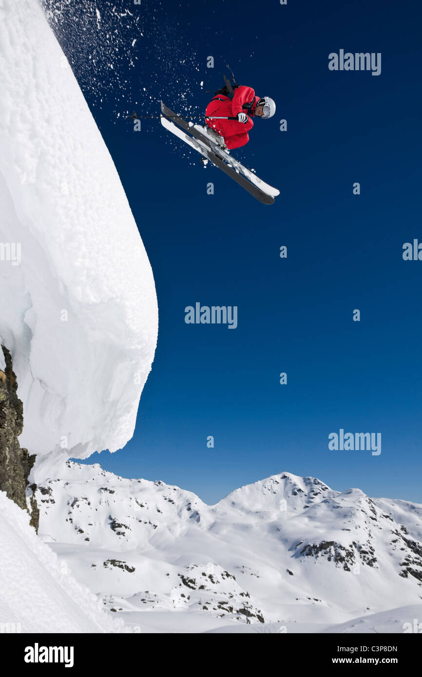 Austria, Salzburger Land, Gerlos, Skier jumping from Mountain, side view, elevated view Stock Photo